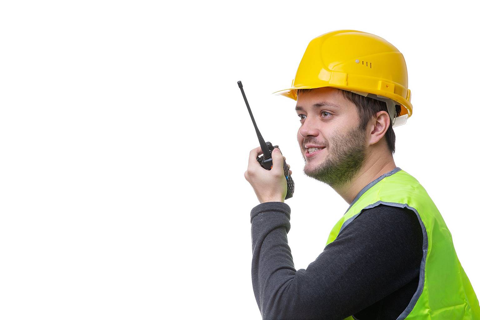 Contractor speaking into a two-way radio with a sarcastic grin.