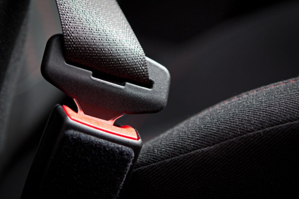 A car seat belt buckled.