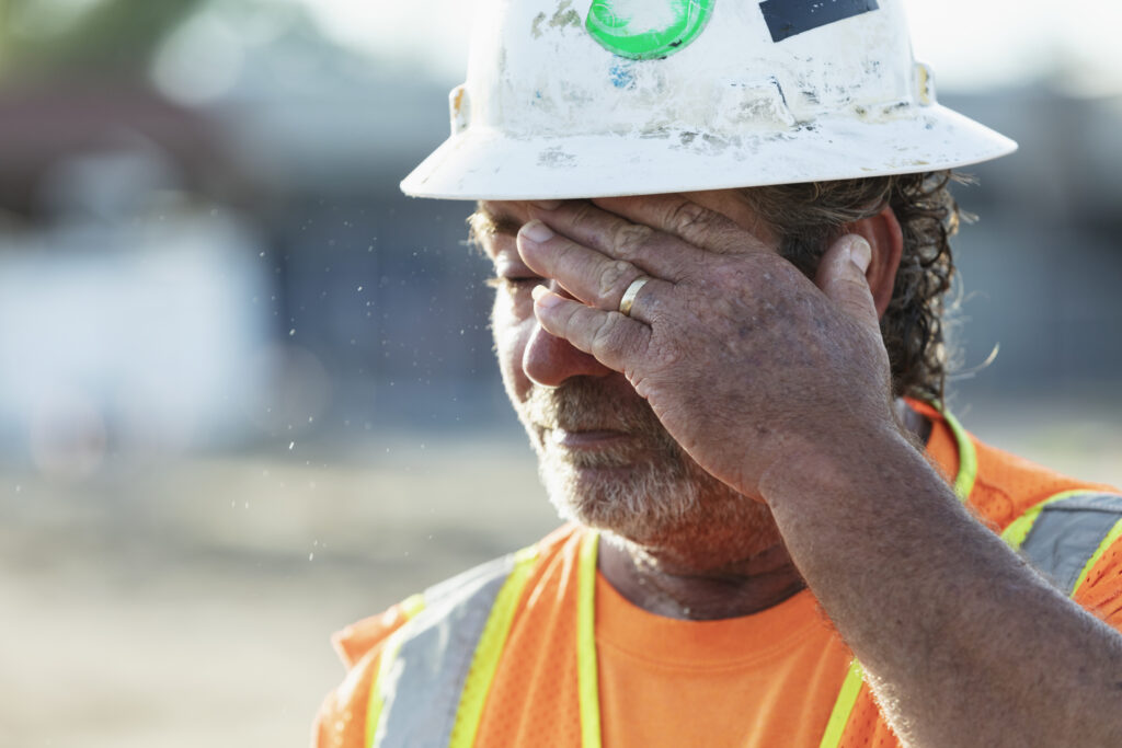 A construction worker showing the effects of working in hot conditions.